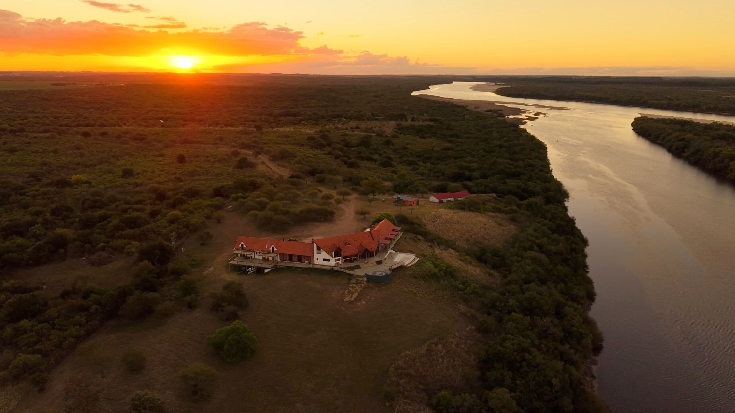Aerial view of Río Mate Lodge at golden hour